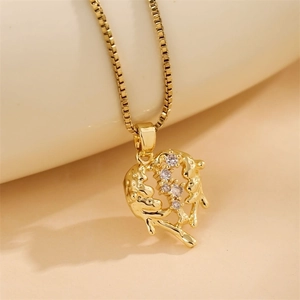 Gold heart-shaped pendant necklace featuring stylized dolphins and embedded gemstones