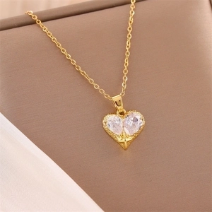 Elegant gold heart pendant necklace with clear cubic zirconia on silk and leather