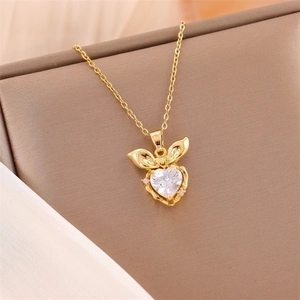 18K gold heart pendant necklace with zircon stone and bow tie accent on a fine chain