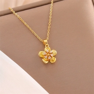 18K gold plated 3D rose flower necklace with clear zircon crystals on jewelry tray