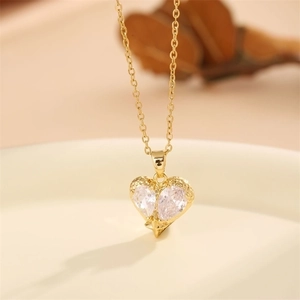 Elegant gold heart pendant necklace with clear cubic zirconia on a minimalist thin chain