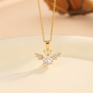 Elegant gold crown and angel wings necklace with a sparkling round gemstone pendant
