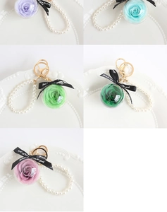 Detailed grid view of eternal flower keychains in purple, blue, green and pink variants