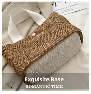 Detail of woven straw tote bag featuring contrast faux leather base and wide canvas strap