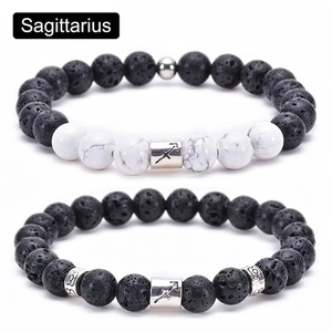 Detail of Sagittarius charm beads with black lava stone and white marble turquoise