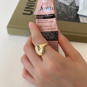 Close-up of minimalist gold-plated 925 silver ring featuring a smooth irregular design