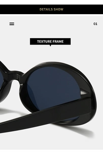 Detail of glossy black oval sunglasses frame showing polished texture and dark lenses