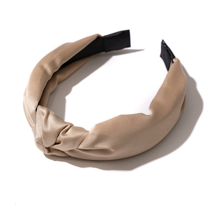 Champagne satin knot headband with wide twisted design and premium silky texture finish