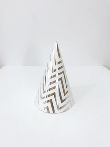Close-up of silver and white wavy pattern party hat made of premium coated cardstock