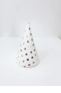 Detailed view of a white cone birthday hat featuring silver metallic polka dot patterns