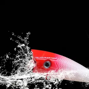 Red head popper lure creating realistic water splashes to attract predatory bass fish