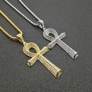 Detailansicht der gold- und silbernen Ankh-Anhänger mit Kristallen auf dunklem Hintergrund