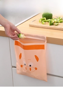Adhesive disposable kitchen trash bag being used on a countertop for easy waste disposal