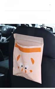 Waterproof adhesive car trash bag with pink cartoon pig pattern shown on car seat back
