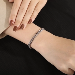 Polished silver chain bracelet for men and women on wrist with lobster clasp detail