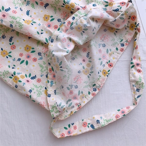 Close-up of soft floral cotton fabric tote with pink and yellow flowers on cream base