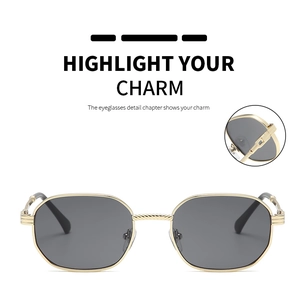 Detail of gold metal frame sunglasses with vintage hexagonal lenses and screw hinges