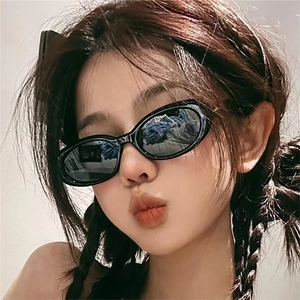 Retro black oval sunglasses for women with trendy star detail on temples and dark lenses