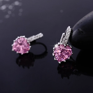 Close-up of pink heart-shaped AAA zircon earrings with sparkling silver-plated prong setting