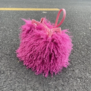 Pink faux sheepskin fur bucket bag with drawstring closure and Y2K aesthetic