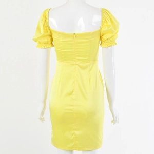 Rear view of yellow satin mini dress featuring puff sleeves and a back zipper detail