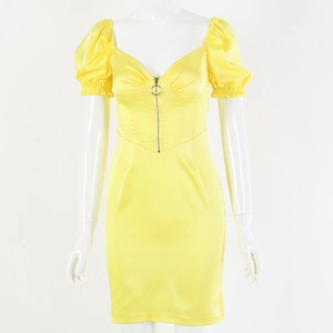 Detail of yellow satin dress with deep V-neck, puff sleeves and front zipper ring