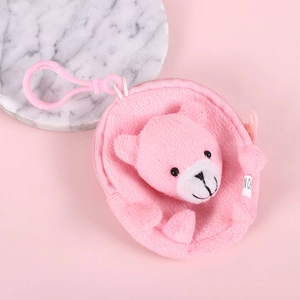 Close-up of pink plush bear coin purse with soft texture and plastic hook on marble base