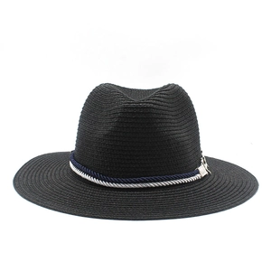 Detail of black straw fedora featuring a blue and white twisted rope and silver charm