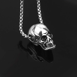 Detailed view of skull pendant with box chain, showcasing realistic punk engraving details