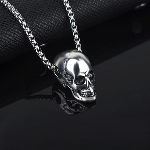 Polished silver skull pendant necklace for men with box chain and mirror reflection