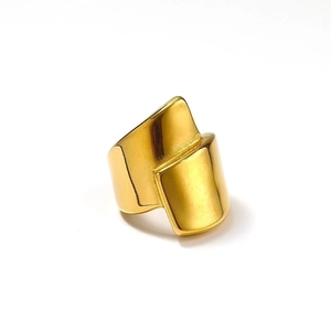 Polished 18k gold irregular wide geometric crisscross ring for women on white background