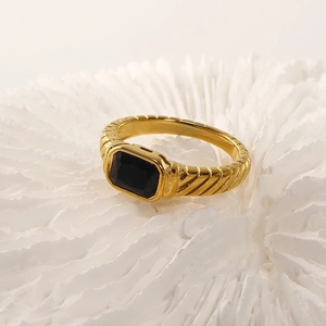 Macro detail of 18k gold plated ring featuring black rectangular stone and ribbed texture