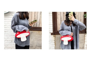 Model wearing a cute red mushroom crossbody bag with gold chain strap over a brown sweater