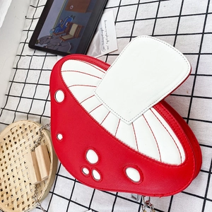 Detail of red and white mushroom PU leather crossbody bag with silver chain strap