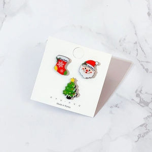 3-piece Christmas acrylic brooch set featuring Santa, tree, and sock on marble background