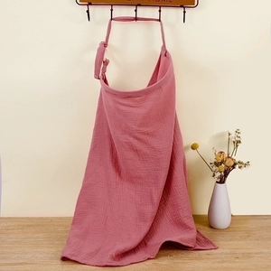 Detailed texture of pink breathable cotton gauze nursing cover with soft natural wrinkles