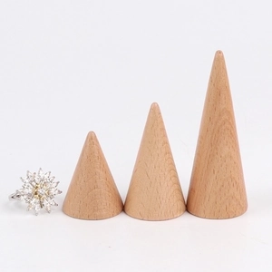 Set of conical solid wood ring display stands with natural beech wood grain on white background