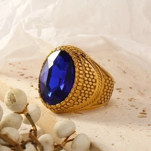 Vintage gold plated stainless steel ring with oval blue gemstone and textured band