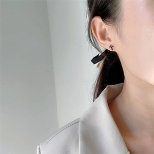 Minimalist S925 sterling silver black cross stud earrings on ear for women and men