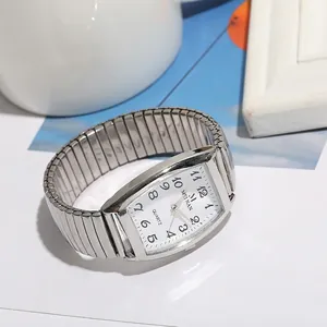 Macro detail of silver rectangular quartz watch with flexible stretch expansion band