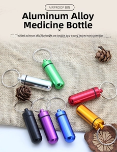 Waterproof aluminum alloy mini medicine bottles in multiple colors with keychains on fabric