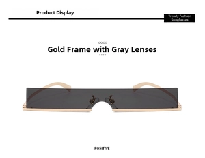 Close-up of narrow rectangular sunglasses with gold metal frame and grey lenses