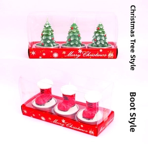 Detail of Christmas tree and boot shaped scented candles in decorative gift box packaging