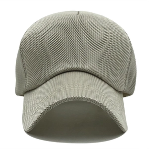 Macro detail of breathable honeycomb mesh fabric on a light grey trucker baseball cap