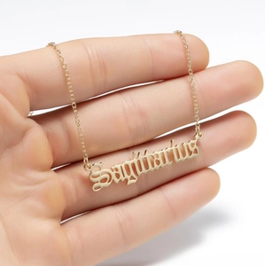 Detailed view of Sagittarius zodiac letter pendant necklace in golden stainless steel