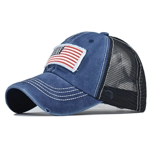 Detail of vintage washed cotton baseball cap featuring US flag patch and distressed brim