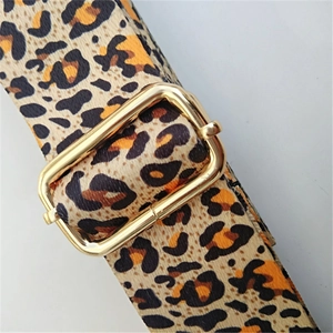 Close-up of leopard print replacement shoulder strap with adjustable gold buckle