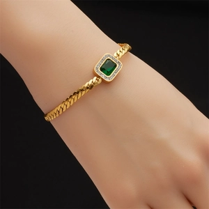 Elegant gold bracelet with emerald-cut green stone and zircon halo on Cuban chain