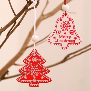 Wooden Christmas tree and bell ornaments with Merry Christmas print on rustic branches