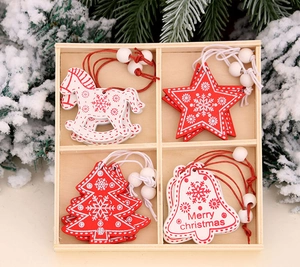 Detail of red and white wooden Christmas ornaments in a grid box with festive pine decor
